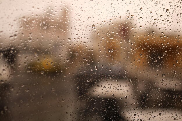 Rainy city background raindrops on window glass on autumn day\
wet home window with raindrops high quality photo