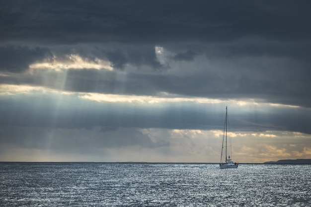 Rainy sky above the yacht in the sea. Ireland.