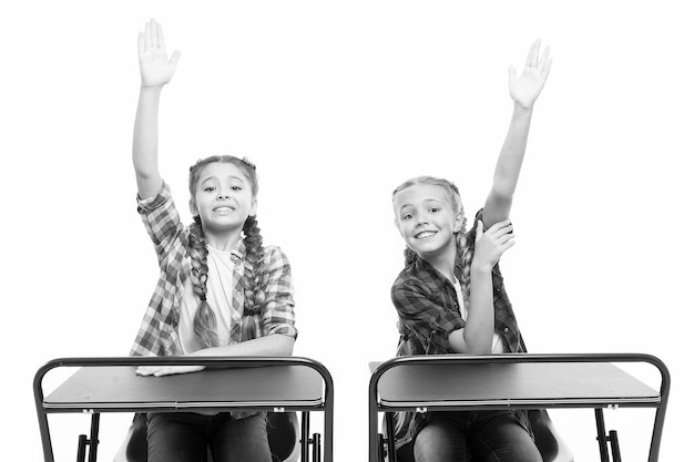 Raise hands to answer Students classmates sit desk Back to school Private school concept Elementary school education Enjoy process of studying Little girls school friends study together