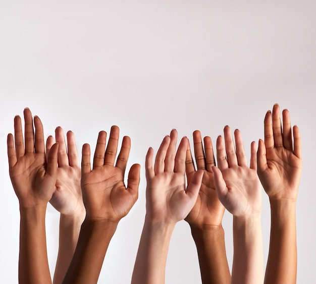 raise your hands if you support diversity cropped shot of a diverse group of people raising their hands