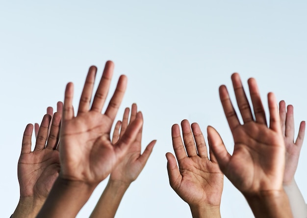 Raise your hands in support of each other Shot of a group of hands reaching up against a white background