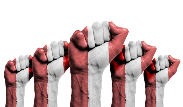 A raised fist of a protesters painted with the peru flag