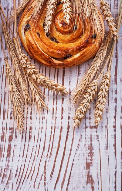 Raisin bun and wheat ears