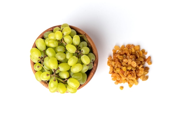 Raisin and green grape isolated on white 