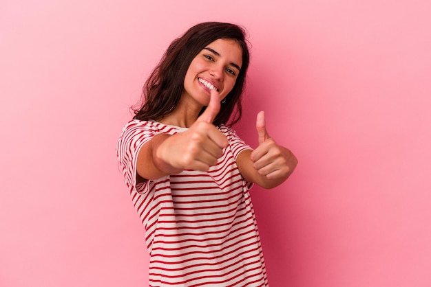 Raising both thumbs up smiling and confident