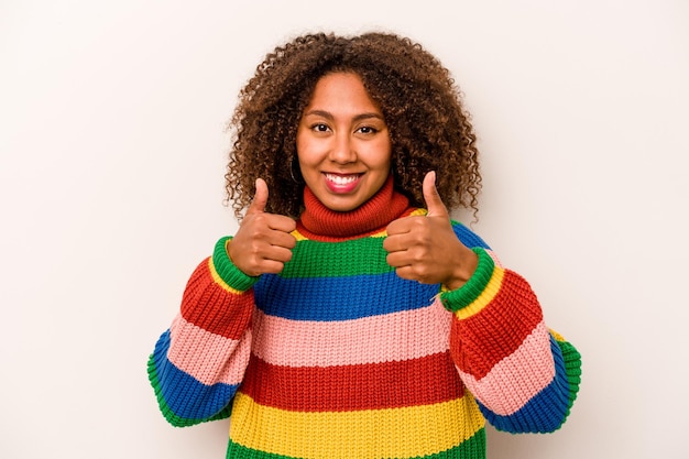 Raising both thumbs up smiling and confident