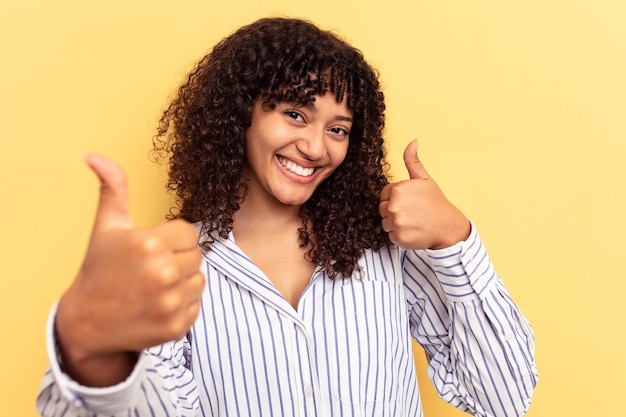 Photo raising both thumbs up smiling and confident