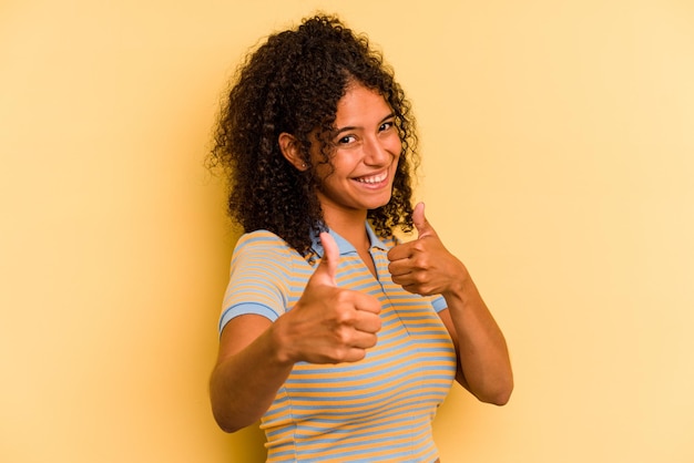 Raising both thumbs up smiling and confident