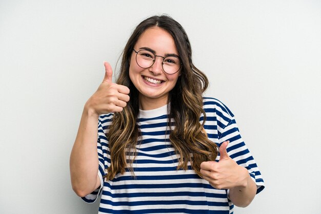 Raising both thumbs up smiling and confident