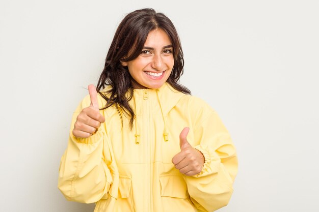 Raising both thumbs up smiling and confident