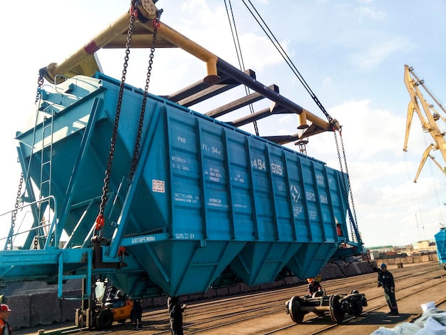 Photo raising the hopper car for unloading on a cargo ship lifting operations in the port