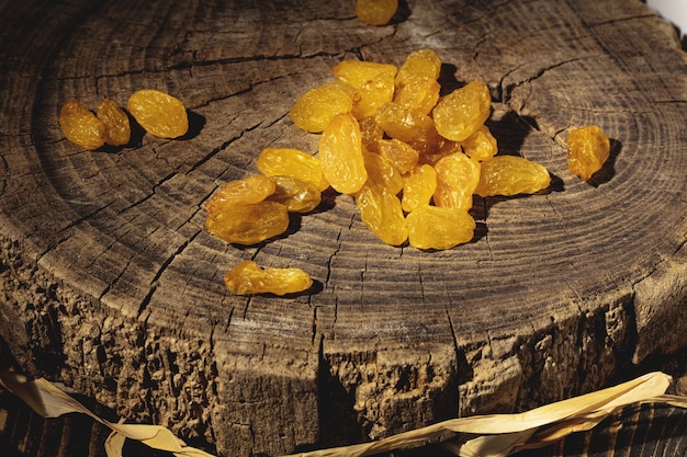 Raisins on dark wooden surface