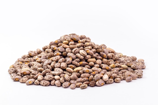 Rajado beans, brazilian beans, seed pile on isolated white surface.