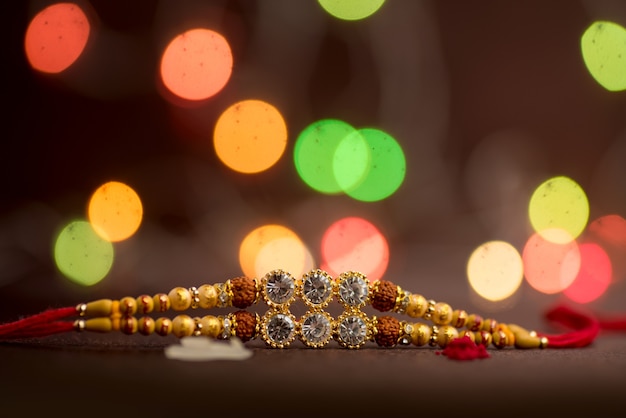 Raksha Bandhan with an elegant Rakhi on bokeh.