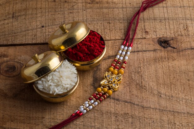 Raksha with rice and kumkum on a wooden table