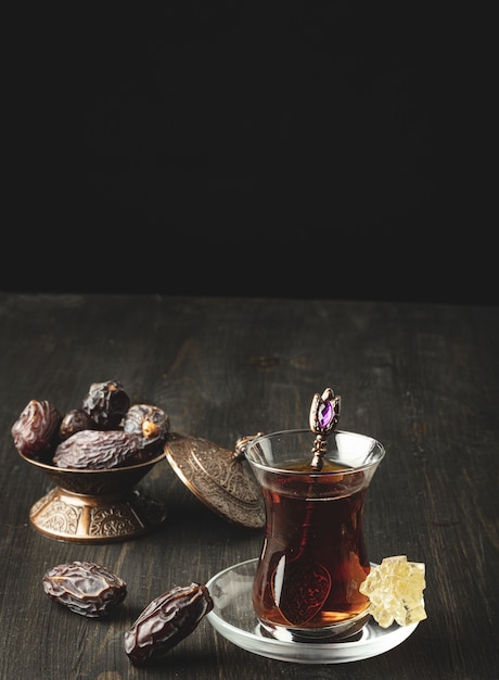 Ramadan composition with cup of tea and dried dates