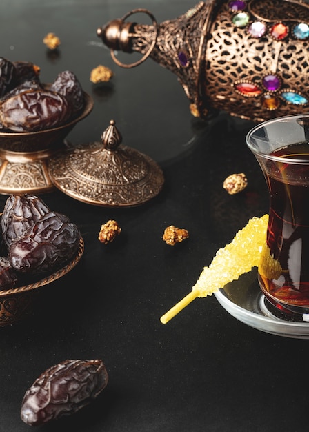 Ramadan composition with cup of tea and dried dates