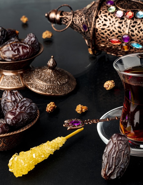 Ramadan composition with cup of tea and dried dates