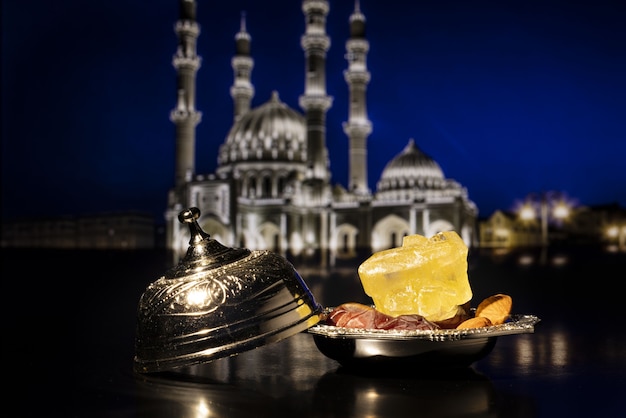 Ramadan composition with dried dates on silver bowl