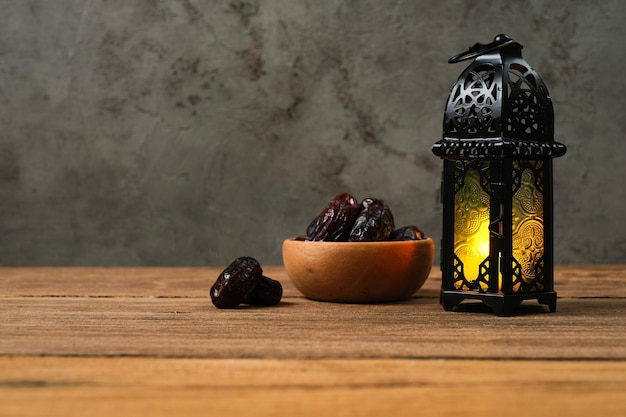 Ramadan and Eid al fitr backgrounds dates with Turkish traditional lantern Light Lamp and Tasbeeh rustic wooden table background Iftar theme image Ramadan Kareem Mubarak