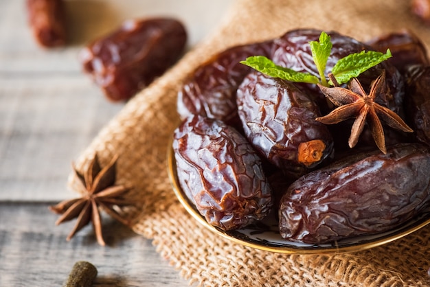 Ramadan food concept. Dates fruit and green Mint leaves in a bowl