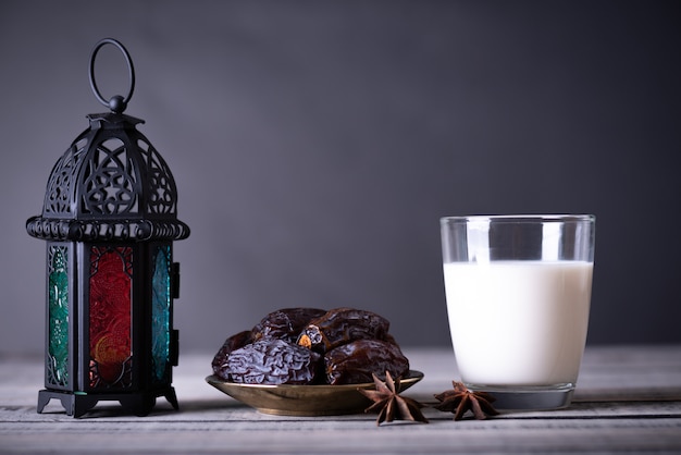 Ramadan food and drinks concept. Ramadan Lantern with Milk, dates fruit