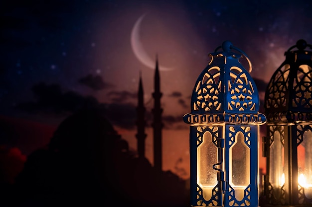 Ramadan Kareem greeting photo of beautiful Arabic lantern and mosque in the background representing the Islamic Holy Month