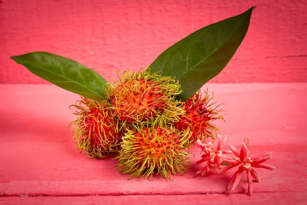 Rambutan fruit on wood color pink 