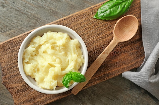 Ramekin with mashed potatoes on table