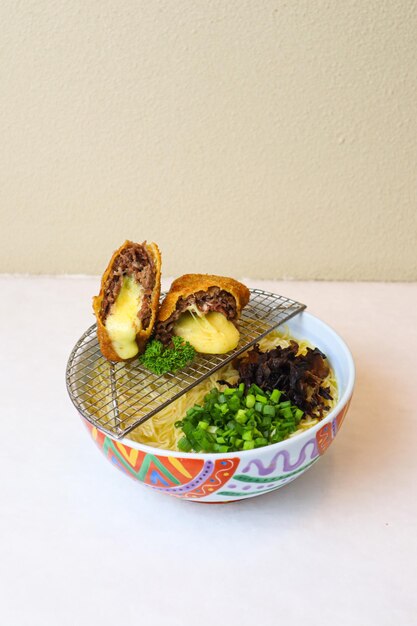 Ramen with beef minced and melted cheesy on white table