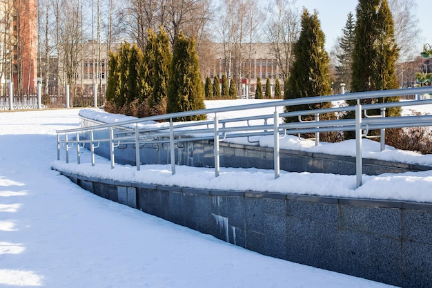 Ramp with railings in the park in the snow