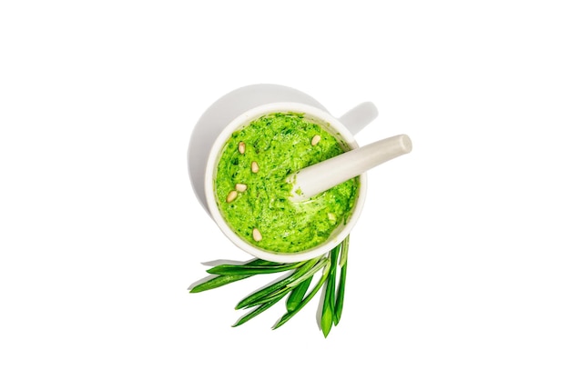 Ramson pesto with olive oil parmesan and pine nuts isolated on white background