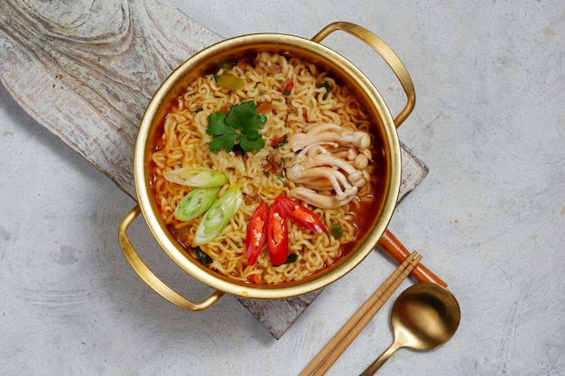 ramyoen or ramyun Korean style instant noodlewith spicy flavour topped with egg yolk chilli