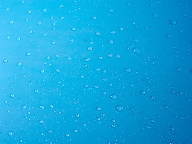 Random water drops on the blue PVC surface