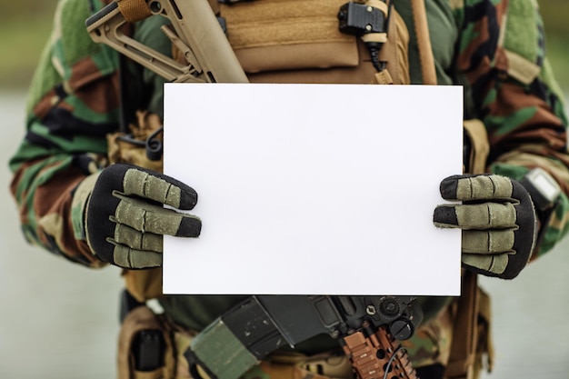 Ranger Showing Paper On Clipboard against a battlefield background