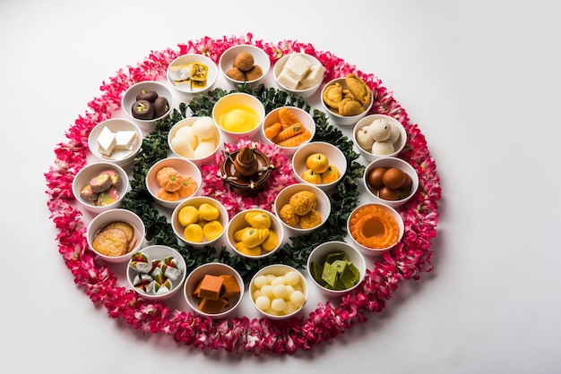 Rangoli of Assorted Indian sweets or mithai in bowl for Diwali or any other festivals, selective focus