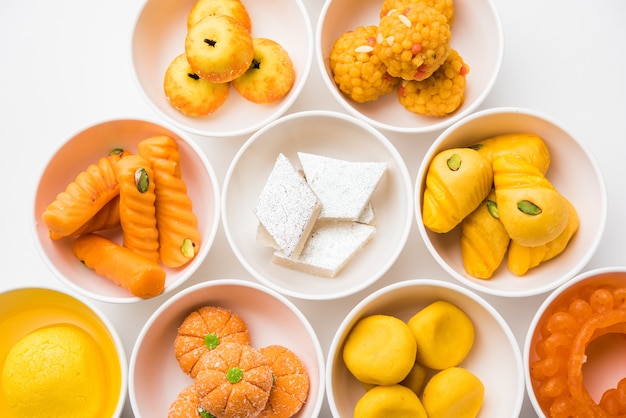 Rangoli of Assorted Indian sweets or mithai in bowl for Diwali or any other festivals, selective focus