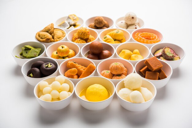 Rangoli of Assorted Indian sweets or mithai in bowl for Diwali or any other festivals, selective focus