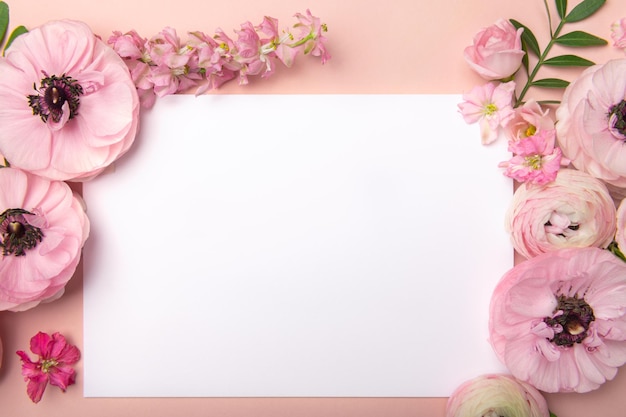 Ranunculus flowers around white card space for text