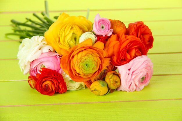 Ranunculus (persian buttercups), ongreen wooden background