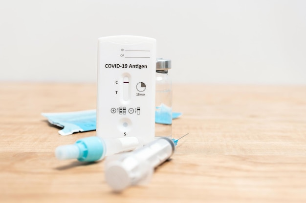 Rapid antigen test kit for viral disease COVID19 with negative result on wooden table with copy space