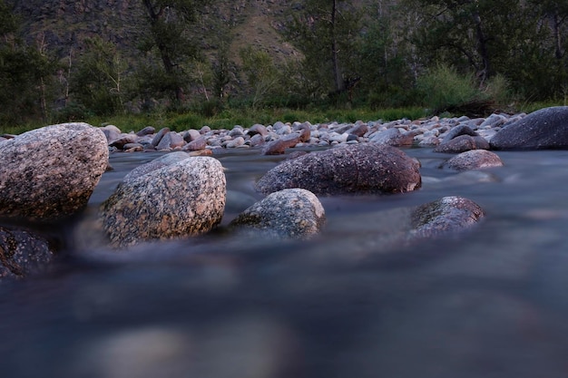 the rapid running of mountain rivers on a quiet summer evening on a long shutter speed