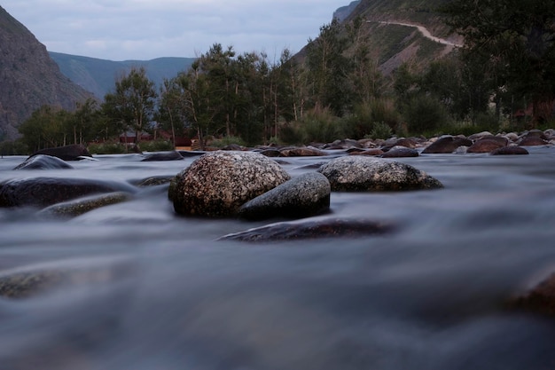 the rapid running of mountain rivers on a quiet summer evening on a long shutter speed