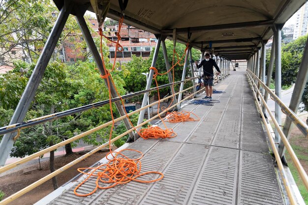 Rappelist organizing abseiling safety material on walkway