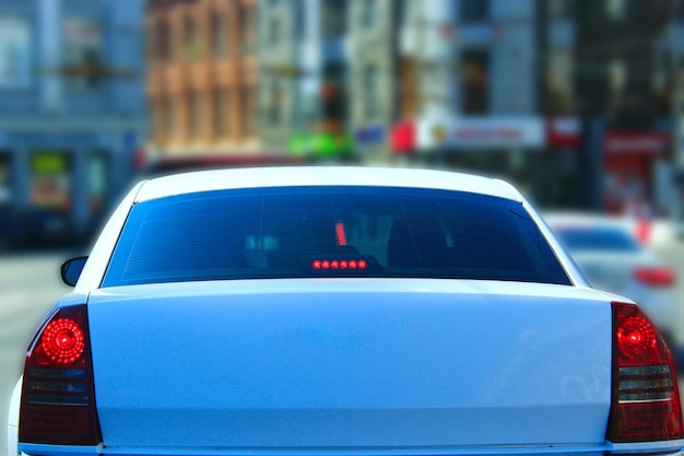 rare view of luxury white car going in the city