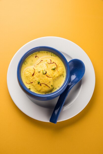 Ras malai or rossomalai is a dessert from Bengal, India. It's a a rich cheesecake without a crust, with Saffron or Kesar &amp; Pistachio toppings. Served in a bowl over wooden or colourful background