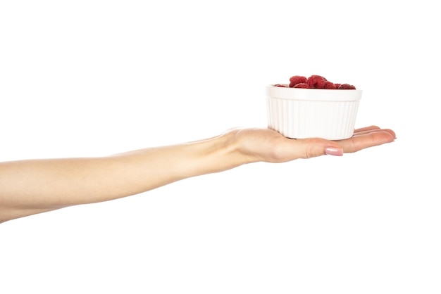 Photo raspberries in hands isolated on white background