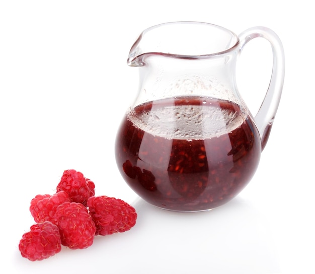 Raspberries and jug with jam isolated on white