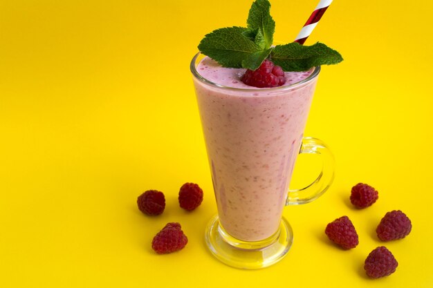 Raspberries milkshake in the glass with mint leaves