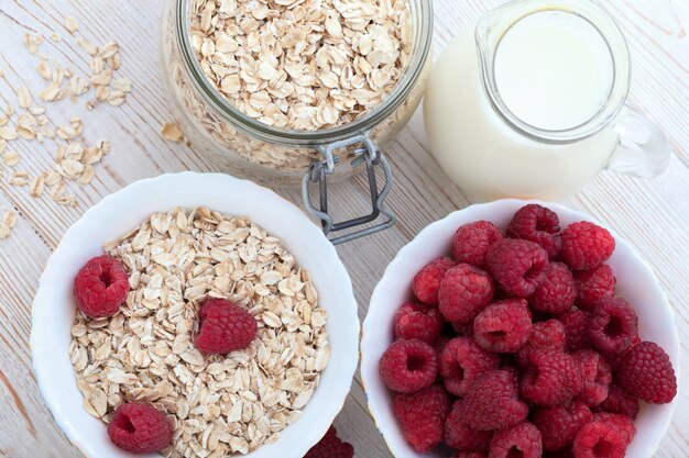 Raspberries and oatmeal on a wooden table